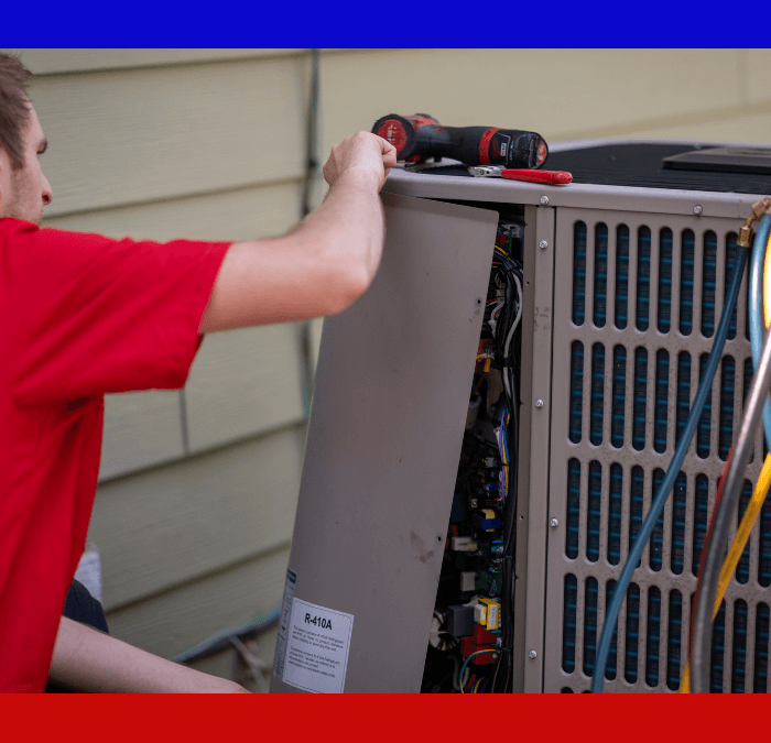 HVAC Master technician removing the cover of an air conditioning unit to provide routine maintenance